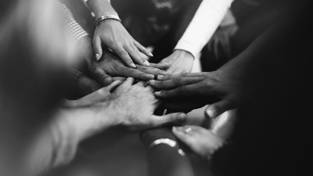 closeup-diverse-people-joining-their-hands